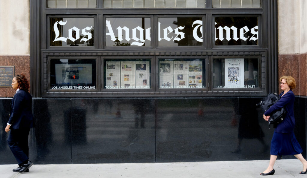 Pedestrians walk outside the Los Angeles Times building