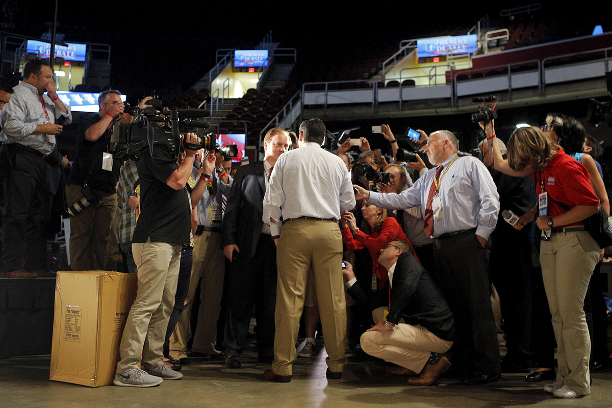 Ted Cruz, seen from behind, speaks to reporters in the media center at the site of the first official GOP debate in Cleveland, Ohio.