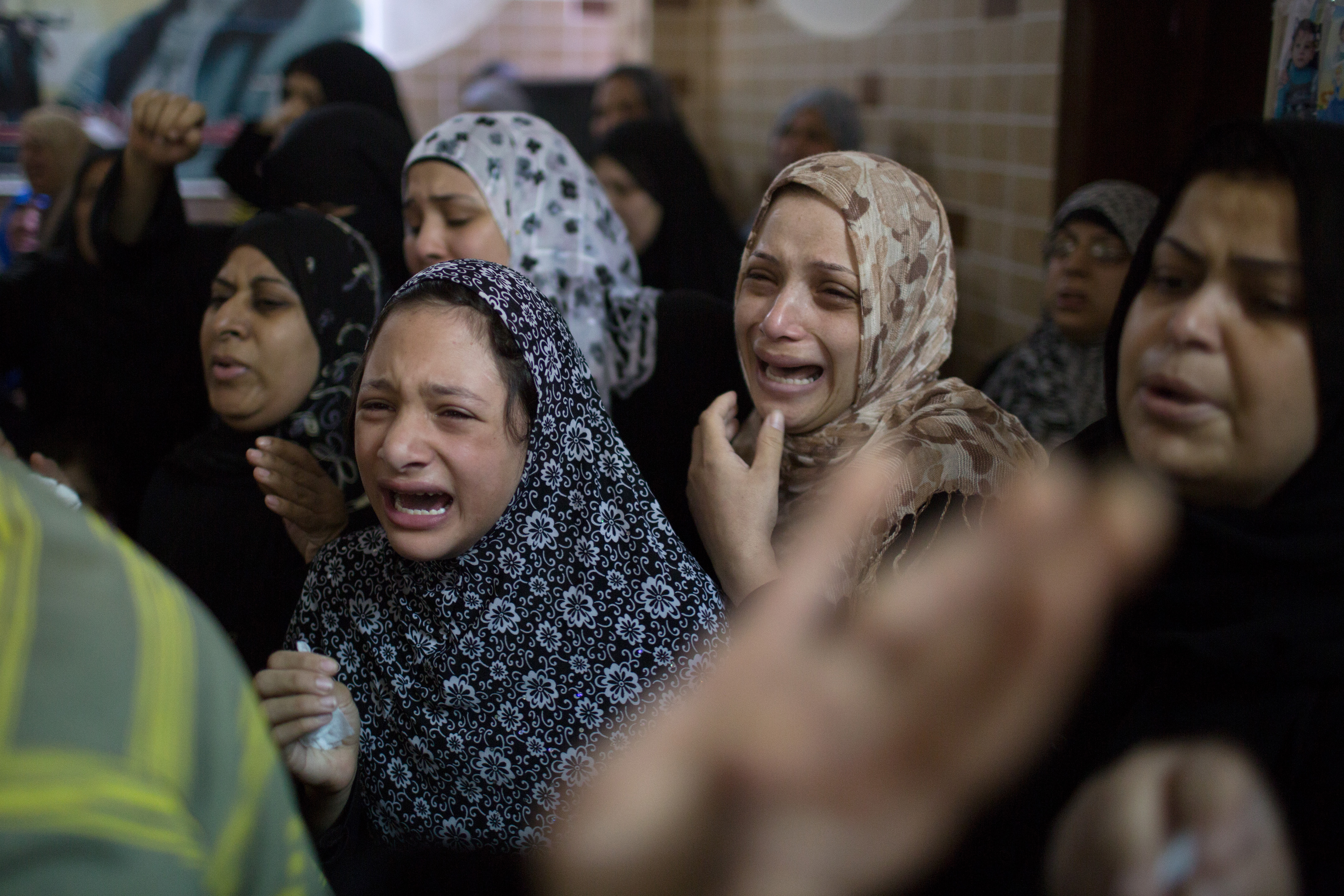 The cross-border war between Israel and Hamas was a major foreign story of 2014. Below, Palestinians prepare to bury a member of Hamas