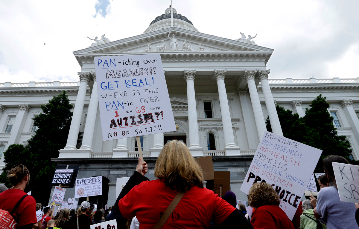 FILE - In this April 8, 2015 file photo, protestors stage a rally at the Capitol in Sacramento, Calif. against Senate Bill 277 which limits inoculation waivers. While most opponents have been respectful of the legislative process, some have depicted one of the bill's authors as Nazi leader Adolf Hitler and left them threatening messages. (AP Photo/Rich Pedroncelli)