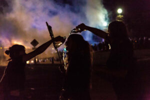 A group of young women help each other after being tear gassed