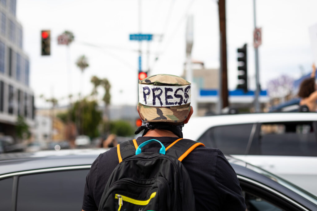 Photographer with an unofficial "Press" badge to identify him among the crowds