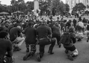 A Little Rock Police officer joins Black Lives Matter protesters