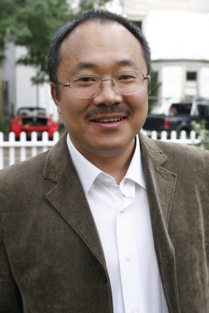 headshot of Yuyu Dong with the white fence of Lippmann House in the background