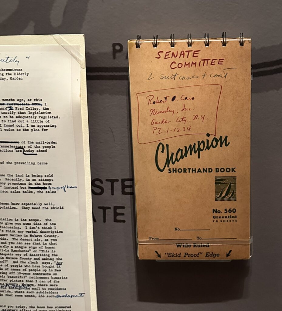 a champion notebook sitting behind a glass enclosure in a museum exhibit