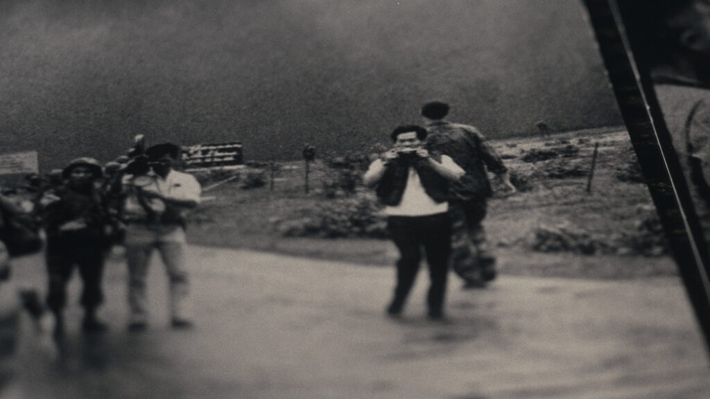 a movie poster for the film, showing the silhouette of a man with a camera taking a picture