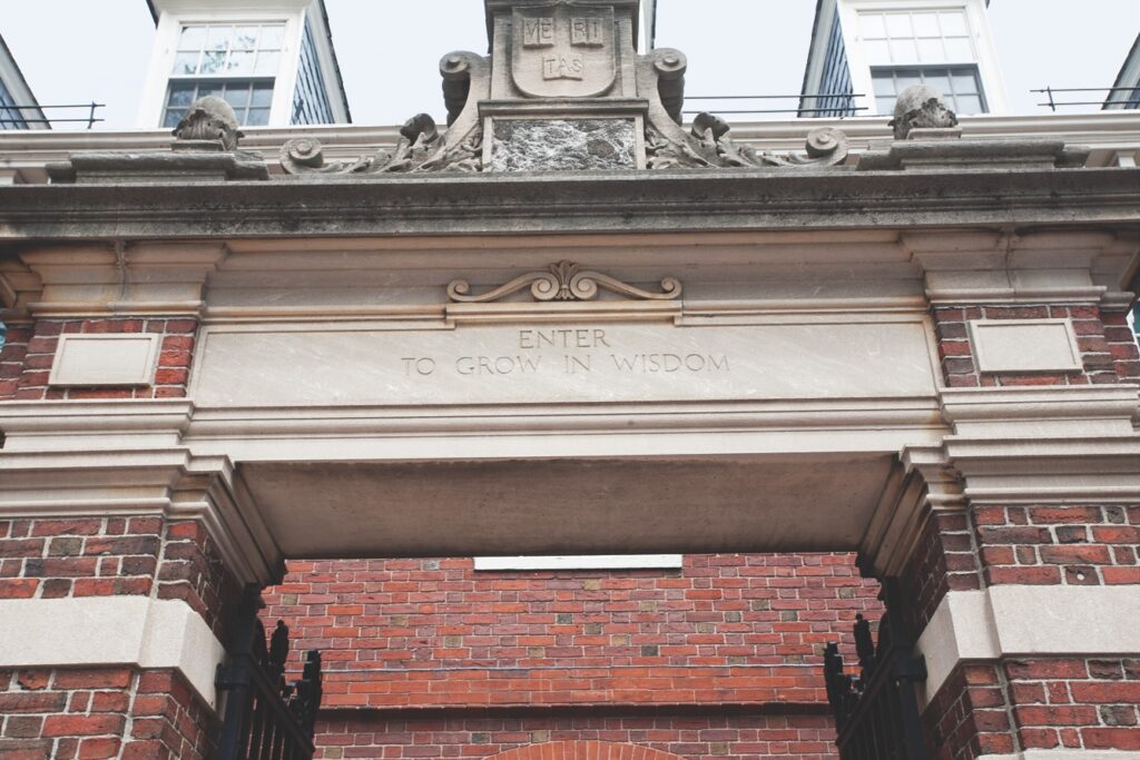 dexter gate at harvard university campus, with the "ve-ri-tas" sign and red brick