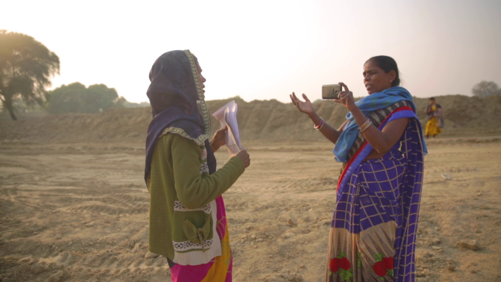 two women standing in a dry desert landscape