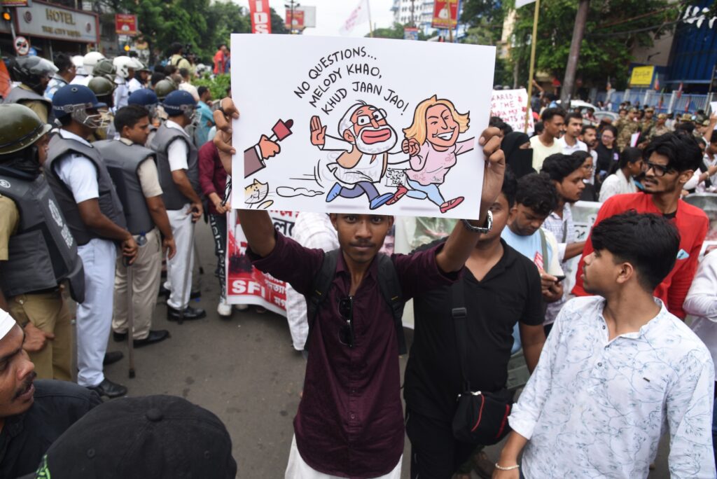 protesters stand outside in the street