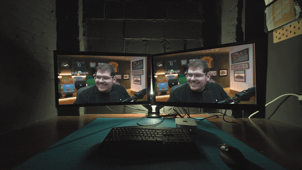 a computer screen flickers with images of CazeTV, Casimiro Miguel, a sports streamer. his logo pops up on screen with images of him streaming and talking to the camera, smiling