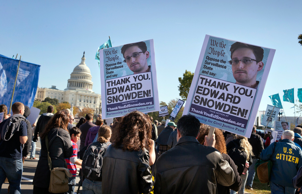 Demonstrators in Washington, D.C. last October protest the NSA’s spying on Americans, as revealed in documents leaked by Edward Snowden. National security expert James Bamford believes journalists get extra NSA scrutiny