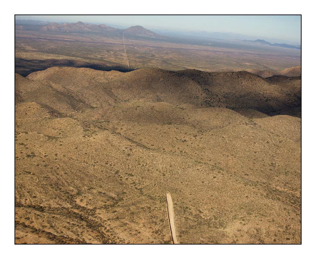 The border fence between Mexico, left, and the United States, right, stops in areas where the terrain is especially harsh and dangerous to cross
