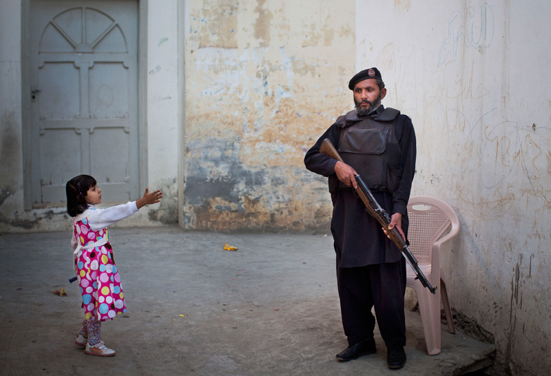 Guarding the home in Mingora, Pakistan of Kainat Riaz, 16, who was shot alongside Malala Yousafzai by the same Taliban gunman, 2012