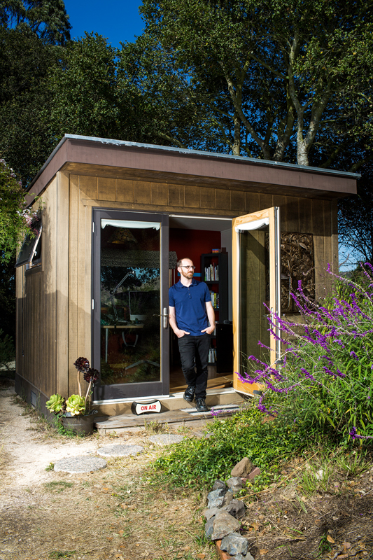 Roman Mars works on his “99% Invisible” podcast in a shed outside his home