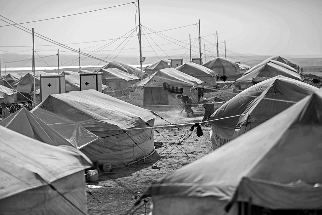 Earlier this fall, an Iraqi woman swept up her tent during a sandstorm. She was one of the many  displaced who had been living in the temporary Khanke camp. 