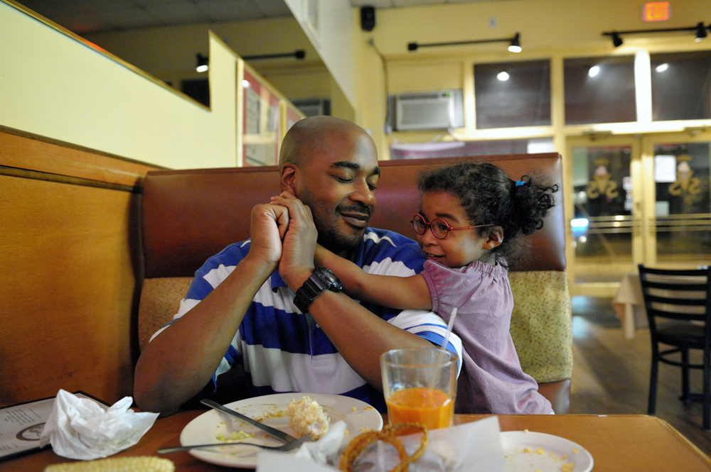 Carlos Richardson and daughter Selah enjoying a quiet moment after dinner. Atlanta, Georgia, October 2012.