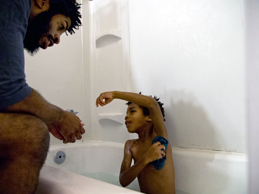 Bath time for Kai. St. Louis, Missouri, December 2014. Terence Mason ensures his son doesn't miss a spot. "Kai is five now, but one day we will have to have 'The Talk' with our son regarding how society will perceive him as a black male, and how to behave in public to minimize unforeseen harmful encounters. It shouldn't be something he should face, but unfortunately that will be our reality and we have to prepare him for it."