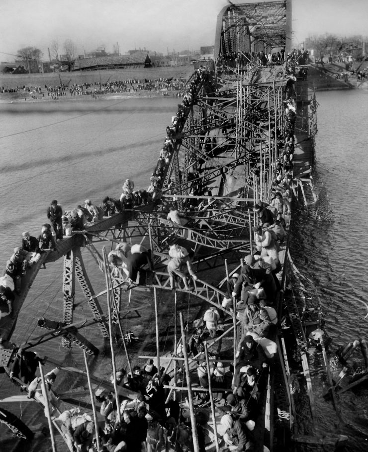Max Desfor won the 1951 Pulitzer Prize for Photography for his coverage of the Korean War, including this photo in which North Korean residents, fleeing the advance of Chinese Communist troops, crawl perilously over a broken city bridge