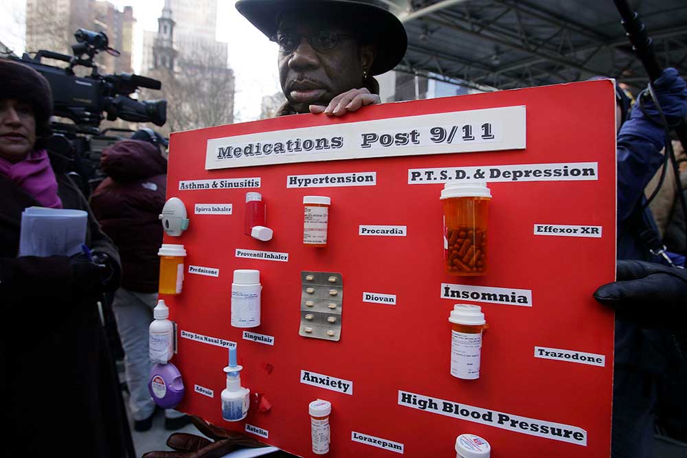 A 9/11 first responder displays his medications on a day President Bush was in New York to address the health issues plaguing Ground Zero workers