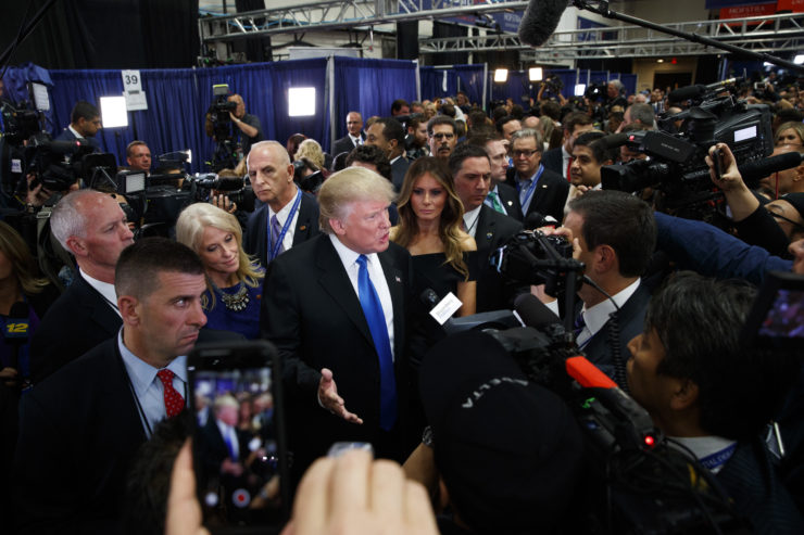 Republican presidential candidate Donald Trump speaks with reporters in the spin room after the first presidential debate against Democratic presidential candidate Hillary Clinton at Hofstra University in late September