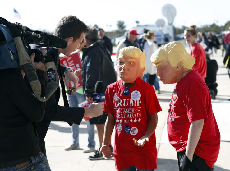 Two young Donald Trump supporters are interviewed by a local television reporter before a campaign rally in Wilmington, N.C. 