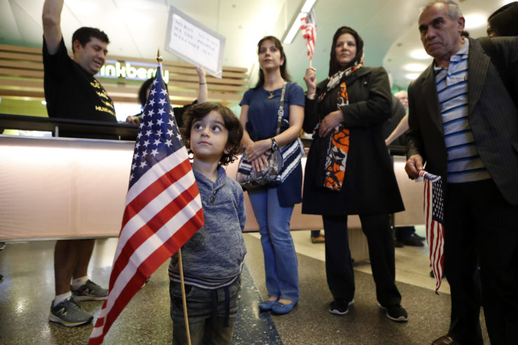 Three-year-old Shayan Ara holds an American flag as protests against President Donald Trump's executive order banning travel from seven Muslim-majority countries continue at Los Angeles International Airport on January 29, 2017