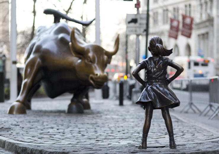 The recently installed Fearless Girl statue faces Wall Street's Charging Bull statue 