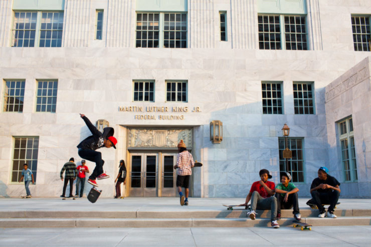 A group of young men skate on the steps of the Martin Luther King Jr. Federal Building in Atlanta, Georgia