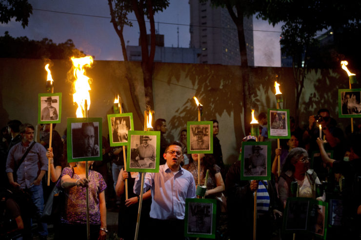 Protestors chant "Justice!" as they carry images of murdered journalist Javier Valdez during a demonstration outside the Interior Ministry in Mexico City