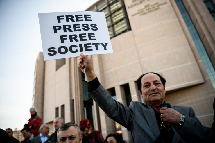 A demonstrator outside of the Istanbul courthouse in April 2016, when journalists from the newspaper Cumhuiyet faced charges of spying after publishing a report accusing Recep Tayyip Erdogan's government of seeking to illicitly deliver arms bound for neighboring Syria