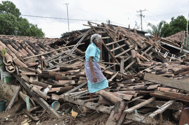 A woman stands amidst the debris of her destroyed home in Agua Caliente, on the outskirts of Acapulco. In his story about climate change’s impact on Acapulco, Jason Margolis examined how tropical storm Manuel had little devastating impact on the city’s ritzy resorts, but destroyed entire communities just miles away