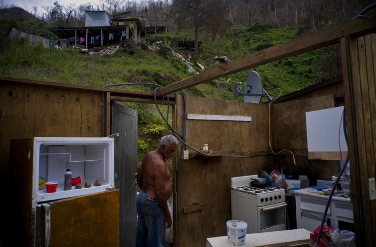 Angel Luis Sortre Vazquez walks into his sister's house, which was destroyed by Hurricane Maria, in the San Lorenzo neighborhood of Morovis, Puerto Rico