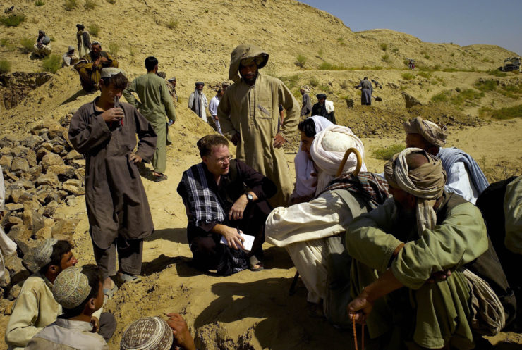 New York Times reporter David Rohde, center, interviews locals in the Kandahar region of Afghanistan, with translation help from local journalist Taimoor Shah (on Rohde's right). Rohde does not like using the term “fixer,” and has helped local reporters like Shah become bylined reporters with the paper.