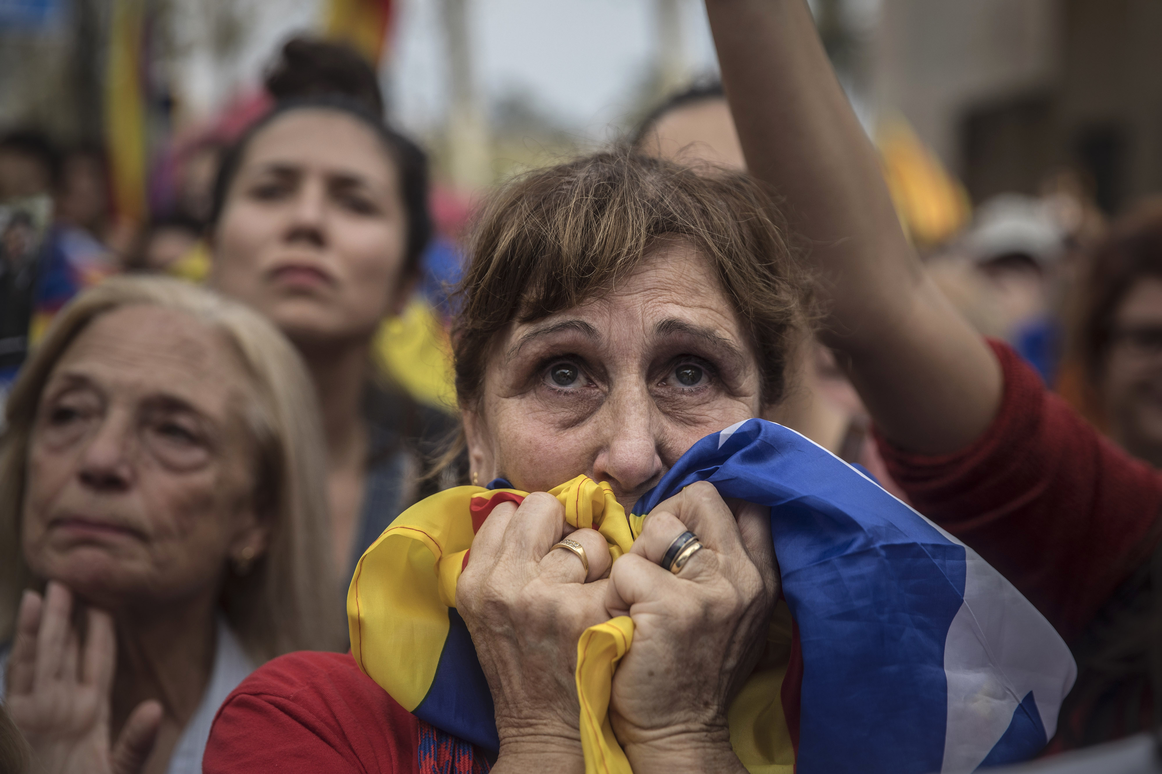 During a 2017 rally in Barcelona, a woman reacts as she watches the Catalan Parliament session during which lawmakers voted to secede from Spain. In an effort to foster civil discourse, Politibot distributed well-reasoned opposing viewpoints on the divisive issue