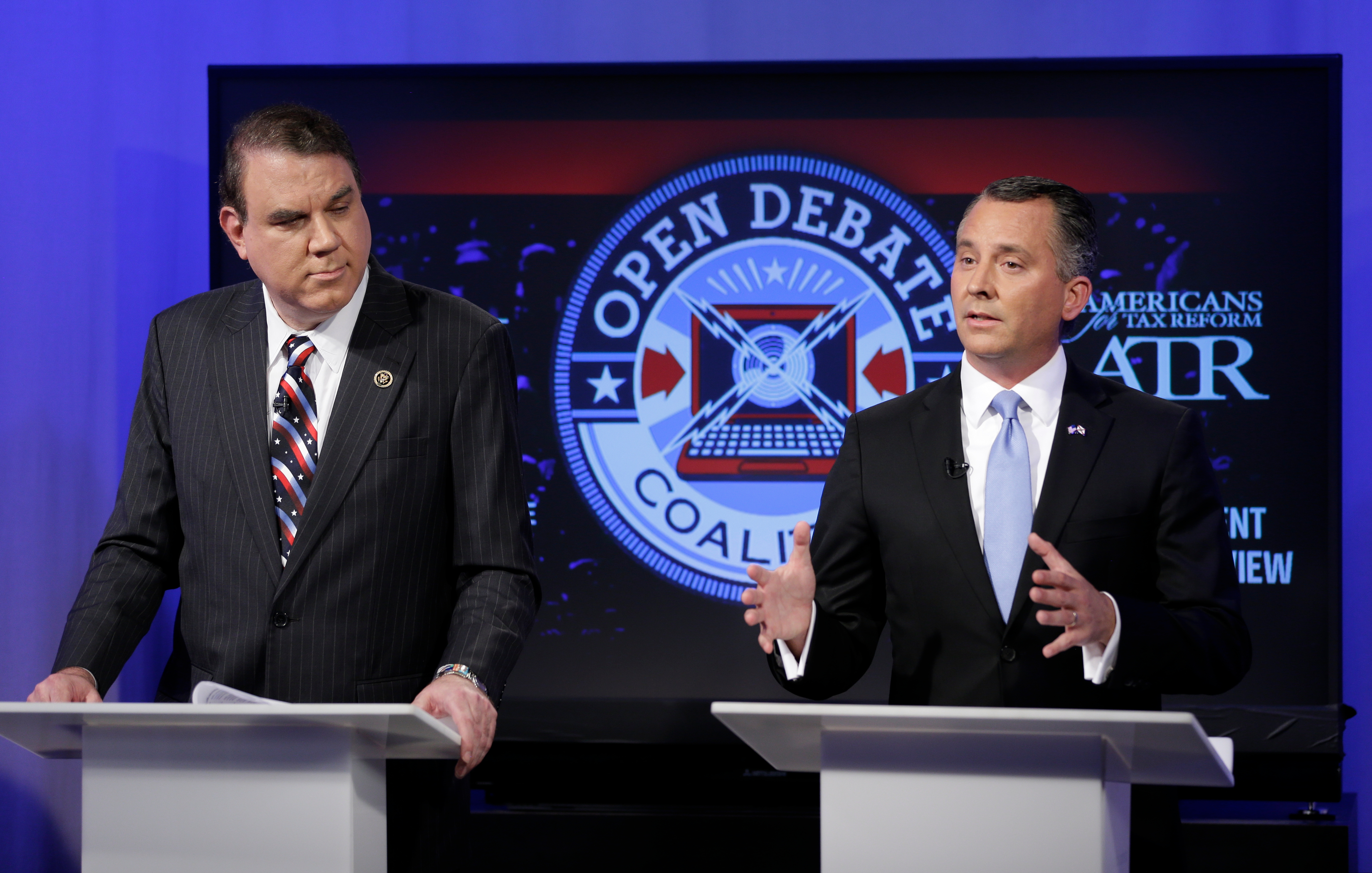 Rep. Alan Grayson, D-Fla., left, and Rep. David Jolly, R-Fla., take part in an open debate for the U.S. Senate in Orlando in April 2016. PolitiFact recently announced the two representatives would serve as ‘reader advocates’ and critique the site’s work, but quickly rescinded the offer to Rep. Grayson after criticism from readers