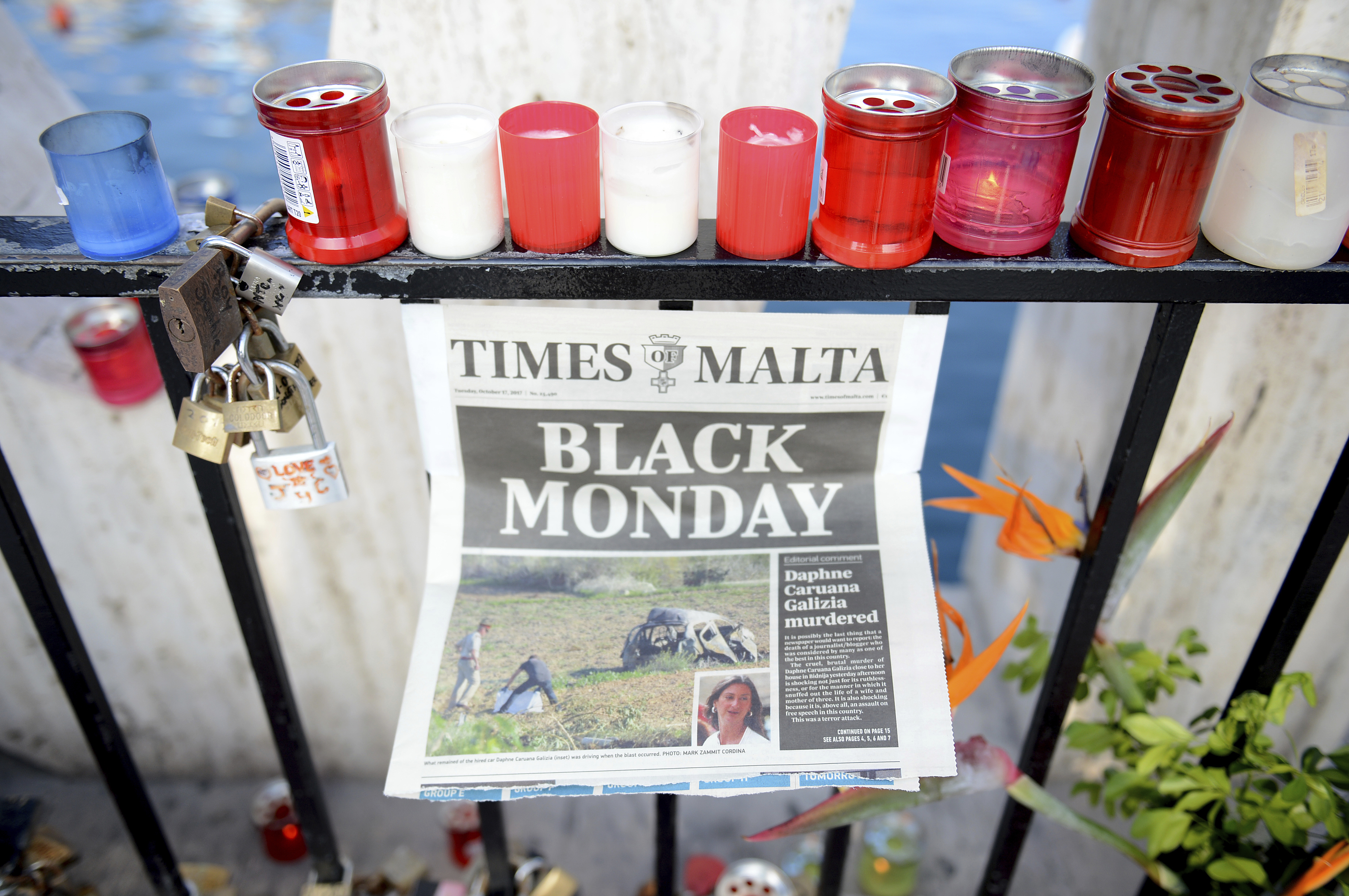 Candles, notes and paper cuttings lie next to the Love Monument in St. Julian, Malta on October 17, 2017, the day after investigative journalist Daphne Caruana Galizia was killed with a car bomb