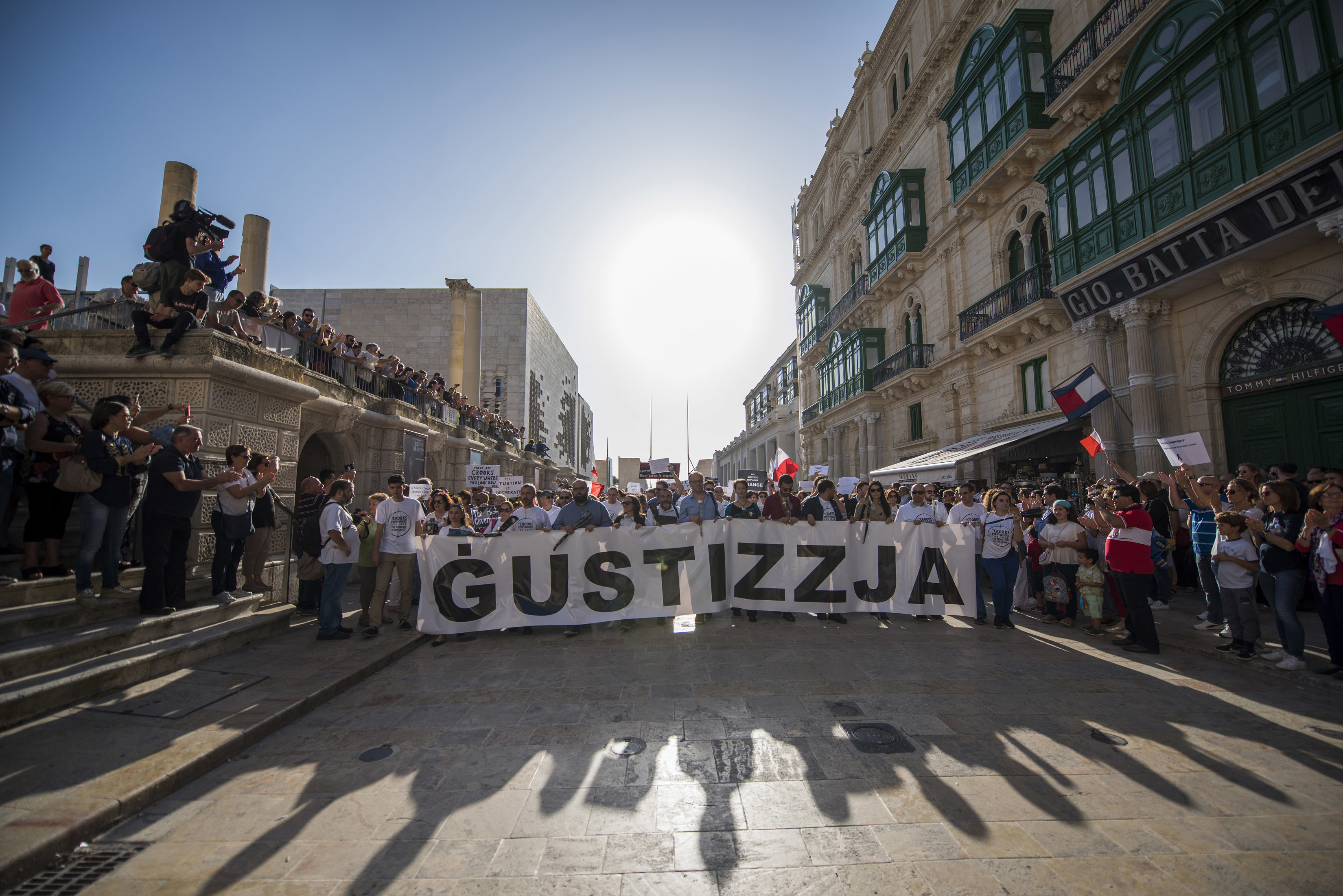 A banner reading "justice" is displayed at an October 2017 rally in Malta to honor investigative journalist Daphne Caruana Galizia, who was killed by a car bomb that month. Forbidden Stories has collaborated with several news organizations and journalists to complete some of Caruana Galizia’s unfinished stories
