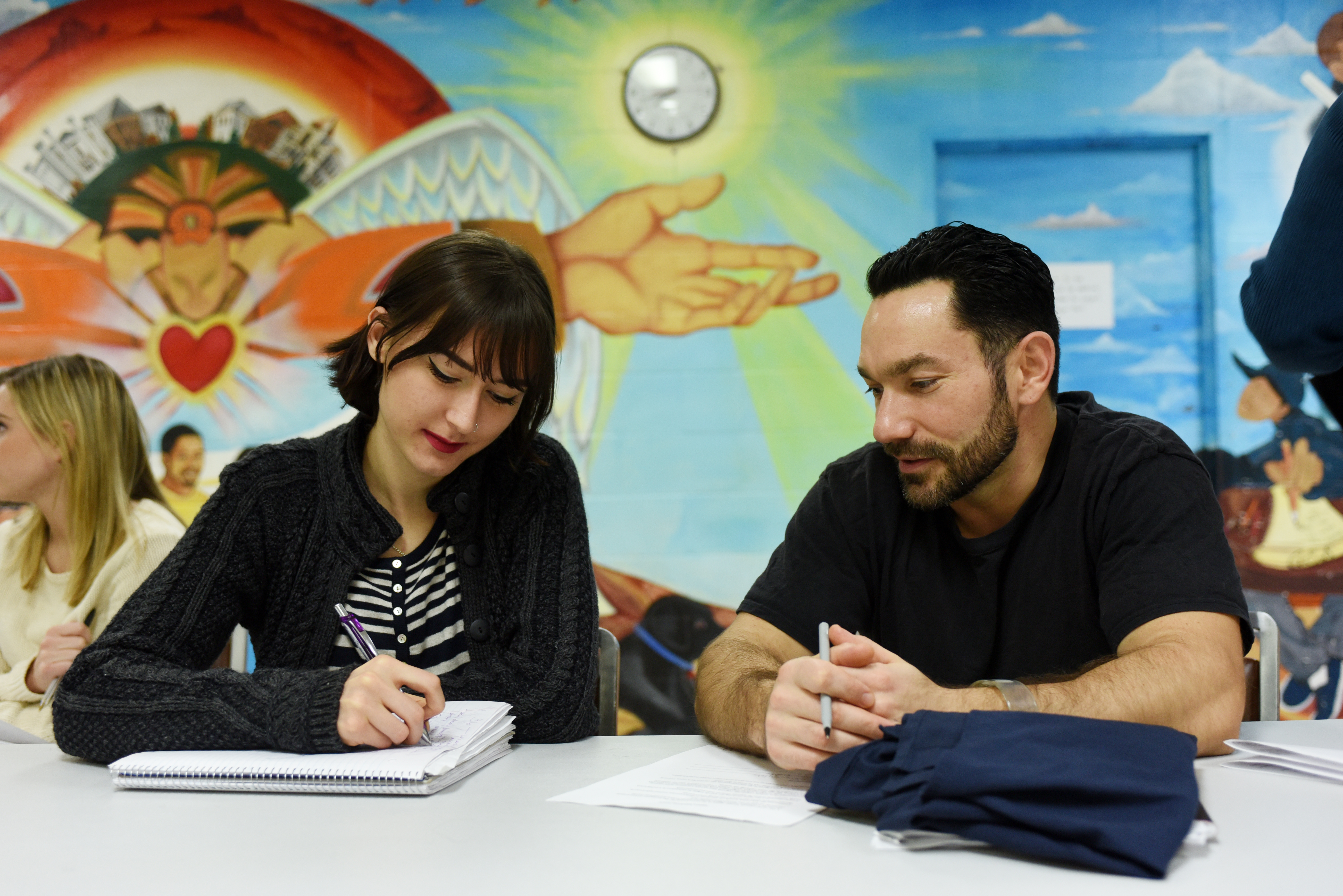 Students Allyson Morin and Eric Zulch, an inmate, at work in a UMass social justice journalism and mass incarceration class taught at the Hampshire County Jail and House of Correction in Northampton, Massachusetts