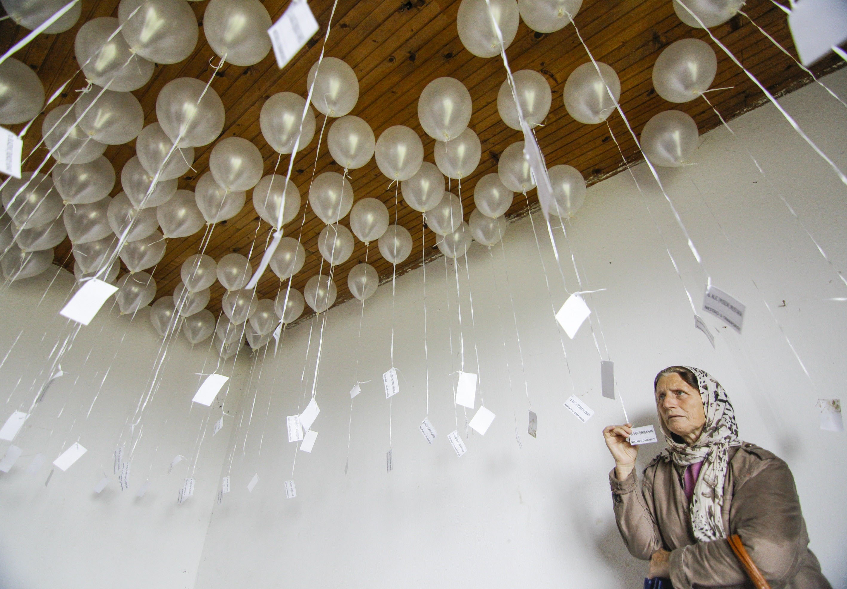 Relatives of those killed in Omarska release white balloons honoring the victims on the 22nd anniversary, in 2014, of the closing of the detention campWar in 1992