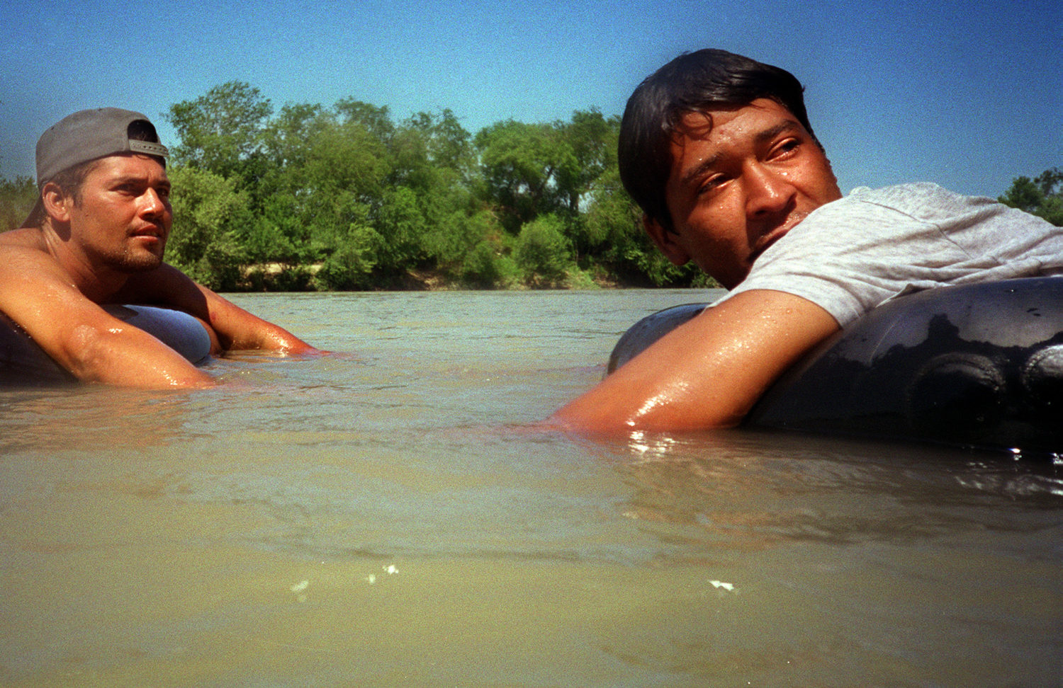 Hondurans Hernan Bonillo and Miguel Olivio react to U.S. Border Patrol agents telling them to move back across the Rio Grande toward Nuevo Laredo, Mexico. Enrique spent several weeks in that city before crossing the border into the U.S. in 2000