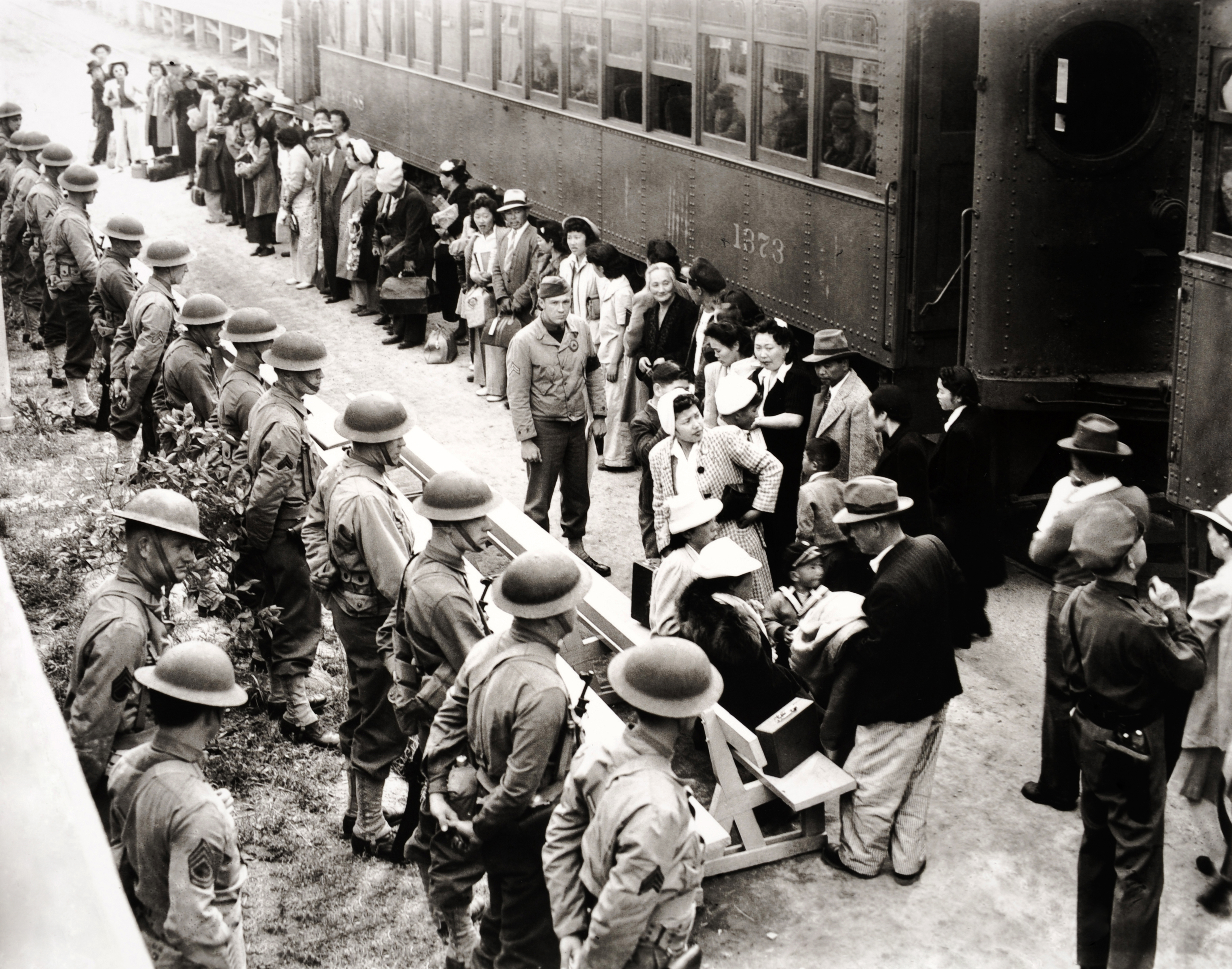 Japanese citizens of the United States en route to their internment at the Santa Anita racetrack, California during World War II, April 1942