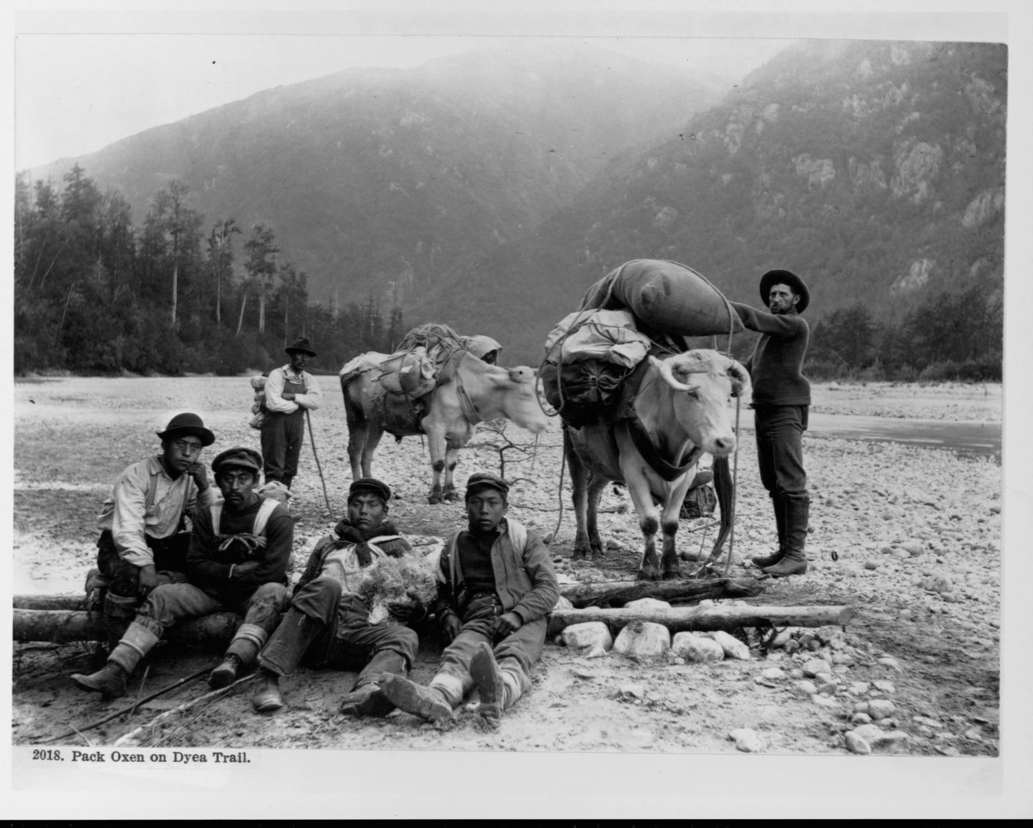 Indigenous Chilkat porters pose with a miner on the Chilkoot Trail in 1897, during Alaska’s gold rush 