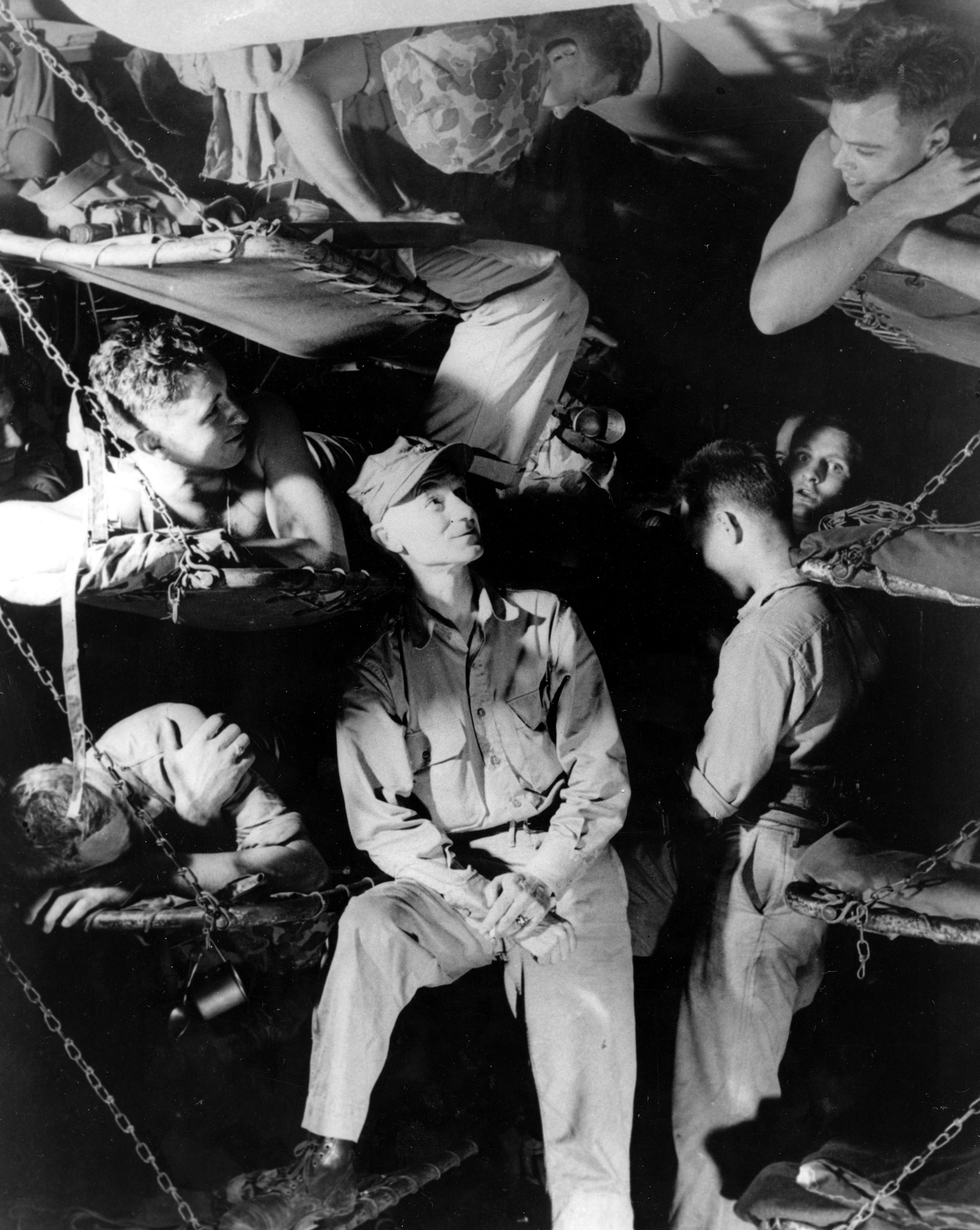 U.S. war correspondent Ernie Pyle, center, Ernie Pyle, center, talks with Marines on a Navy transport en route to Okinawa in 1945 during World War II