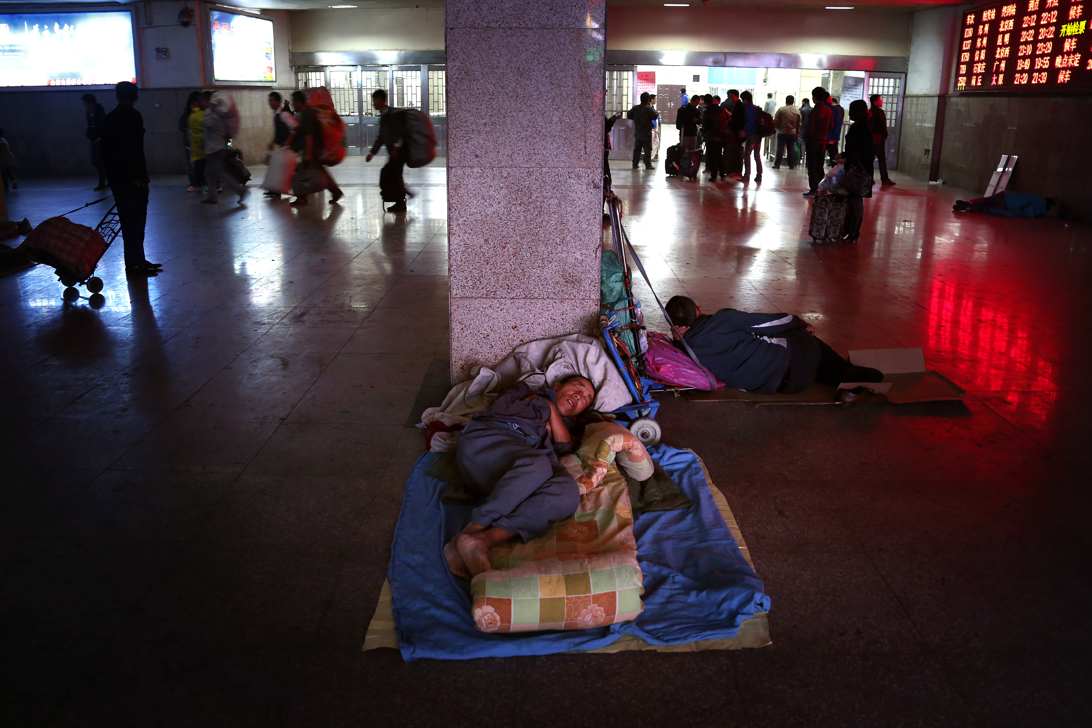 Homeless men sleep at a train station in Zhengzhou in 2012. Sun Zhigang was detained under China’s custody and repatriation system, which largely targeted migrants and homeless people