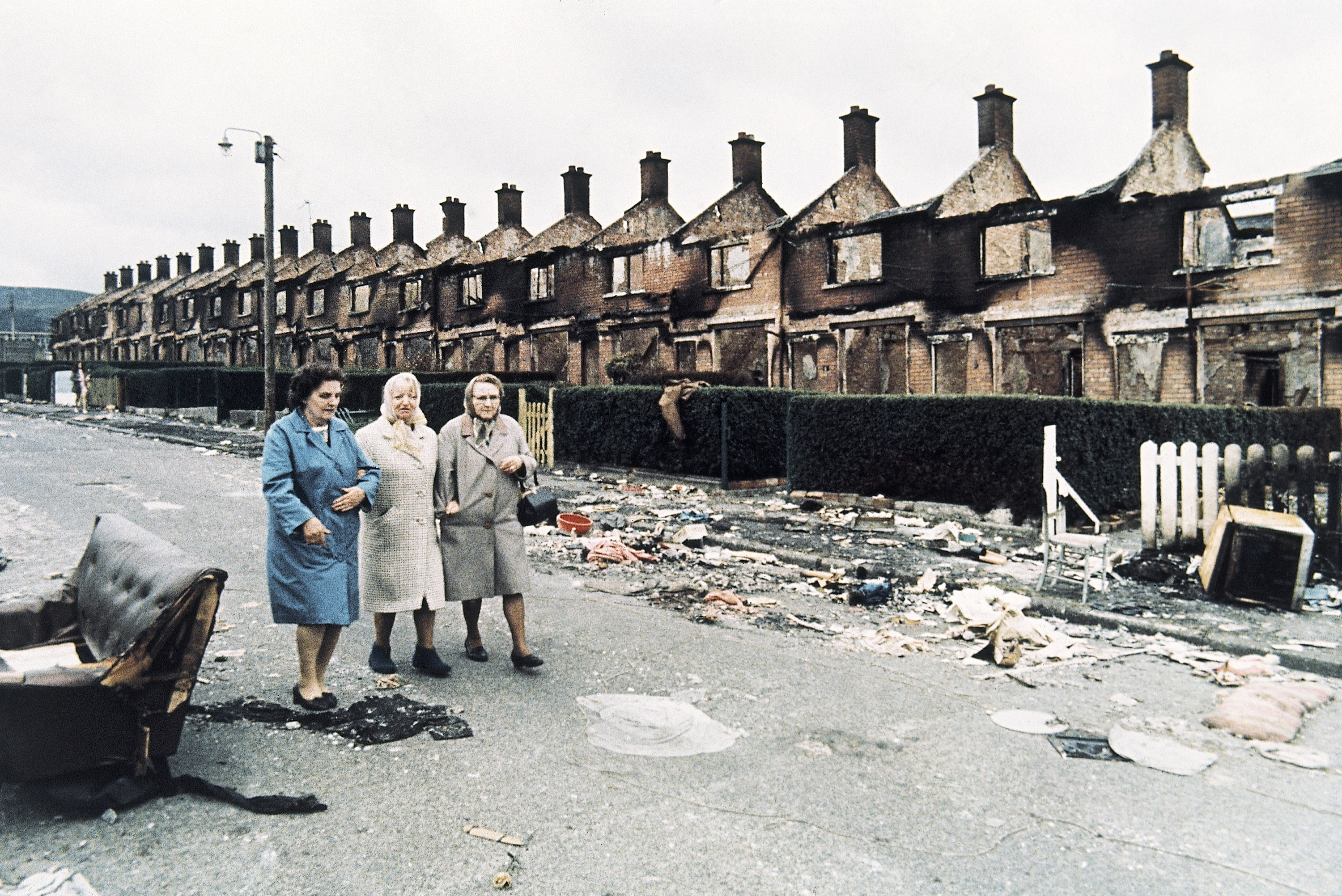 Local women walk through the rubble in Belfast, Northern Ireland on Aug. 17, 1971. In the background are rows of burnt out houses set alight during a "scorched earth" action by residents who had fled to other parts of Belfast in the wake of continuing violence