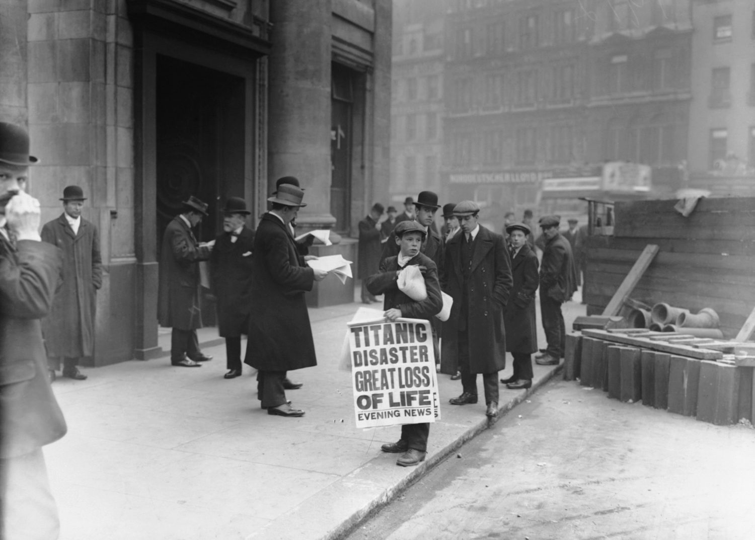 A London newsboy sells papers bearing news of the Titanic sinking on the day after the disaster