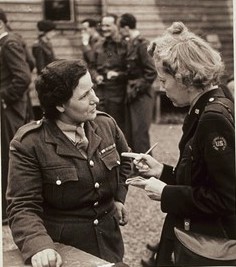 Cowan talks to a Polish woman in uniform during WWII