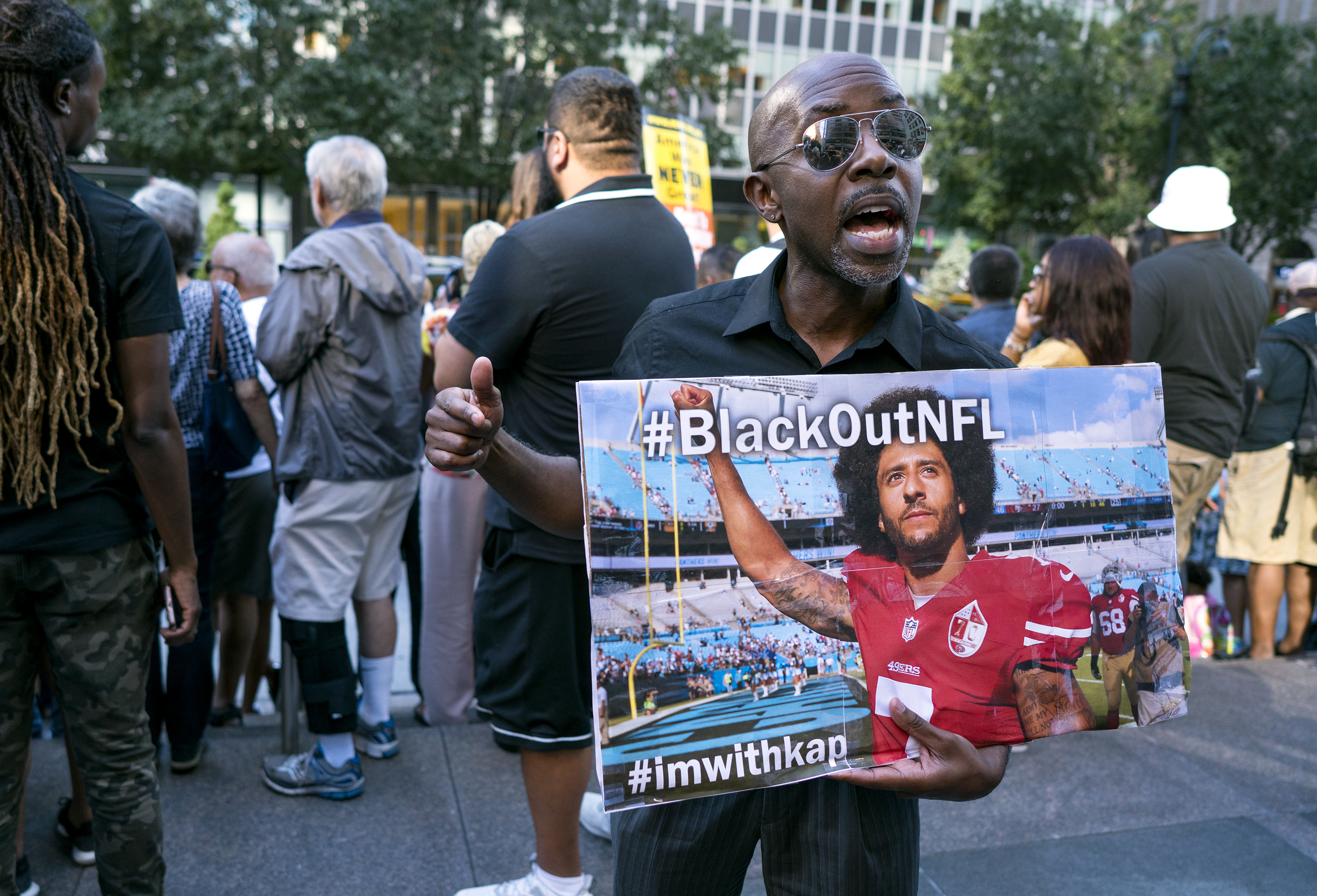 Eric Hamilton joins others gathered in support of unsigned NFL quarterback Colin Kaepernick in August 2017 in front of NFL headquarters in New York. Player protests and Kaepernick’s exile from the NFL received a breadth of media coverage from old and new sports media alike 