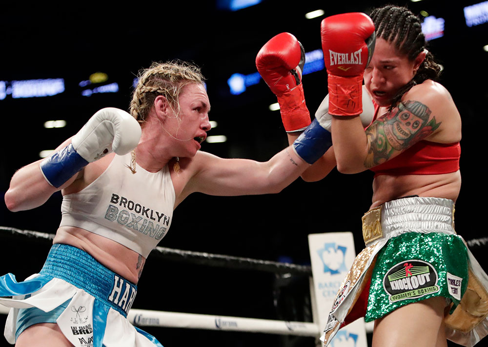 Boxing champion Heather Hardy (left), shown here fighting Mexico’s Paola Torres during an April 2018 match, told her story—in her own words—to NPR’s “Only a Game”