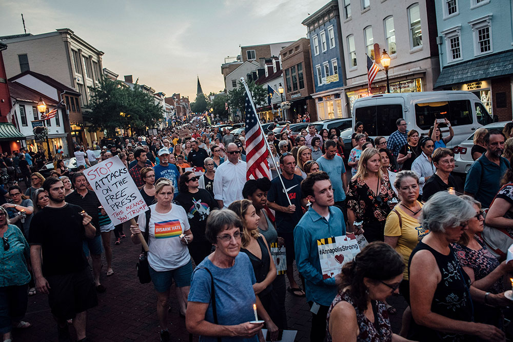 People walk on Main Street in Annapolis, Maryland for a vigil for the victims of the shooting at the Capital Gazette in Annapolis in June 2018